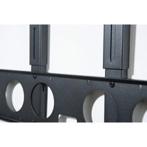 Close-up of the Alphason AS8001 Playbar TV Mount Bracket, a black metal mount attached to a white wall, featuring circular cutouts and vertical mounting rails.