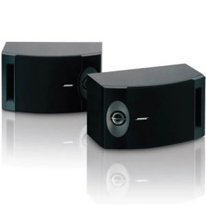 Two black Bose 201 Direct/Reflecting Speaker System speakers are placed side by side on a reflective surface, with the Bose logo visible on the front of each speaker.