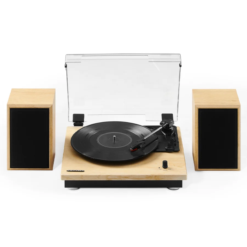 Crosley Brio Record Player Shelf System With Speakers The crosley brio record player shelf system with speakers, featuring a clear dust cover and spinning a vinyl record, is accompanied by two wooden speakers with sleek black fronts.