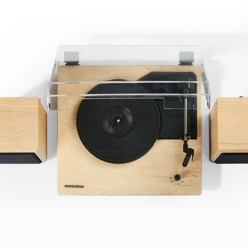 Crosley Brio Record Player Shelf System With Speakers The crosley brio record player shelf system with speakers, featuring a wooden turntable with a clear dust cover and two matching wooden speakers, is displayed against a plain white background.
