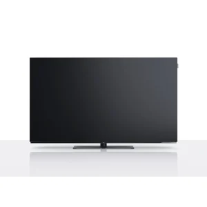 Loewe We. SEE 55 OLED TV shown front-on with its slim black display and table stand.